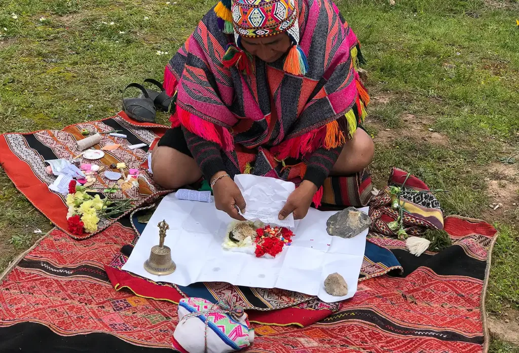 Despacho ceremony ingredients laid out on white paper before assembly in Chinchero